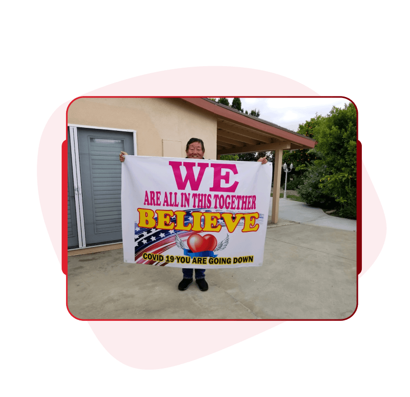 Team member holding a custom branded corporate sign outdoors