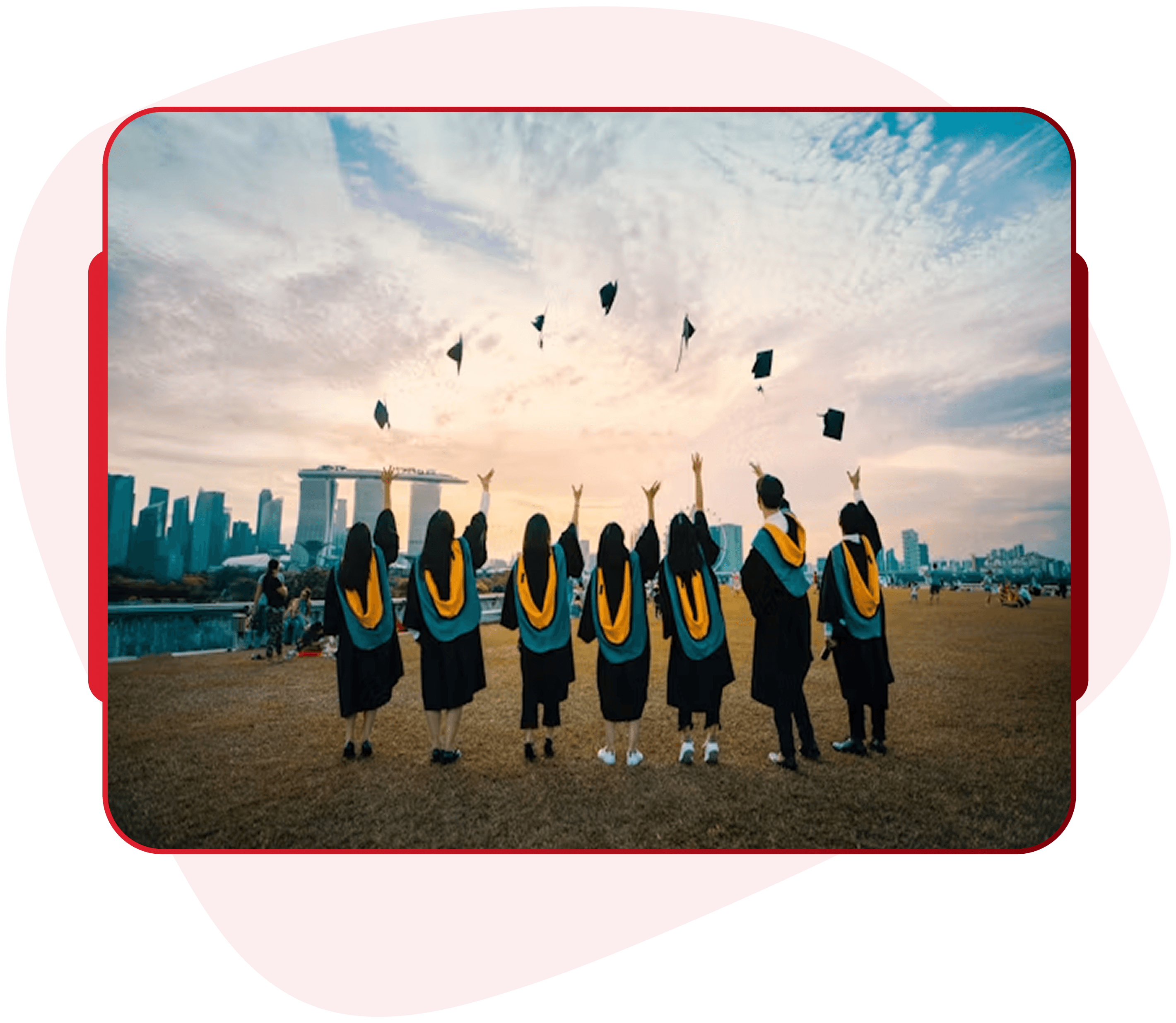 Graduates throwing caps in celebration at sunset