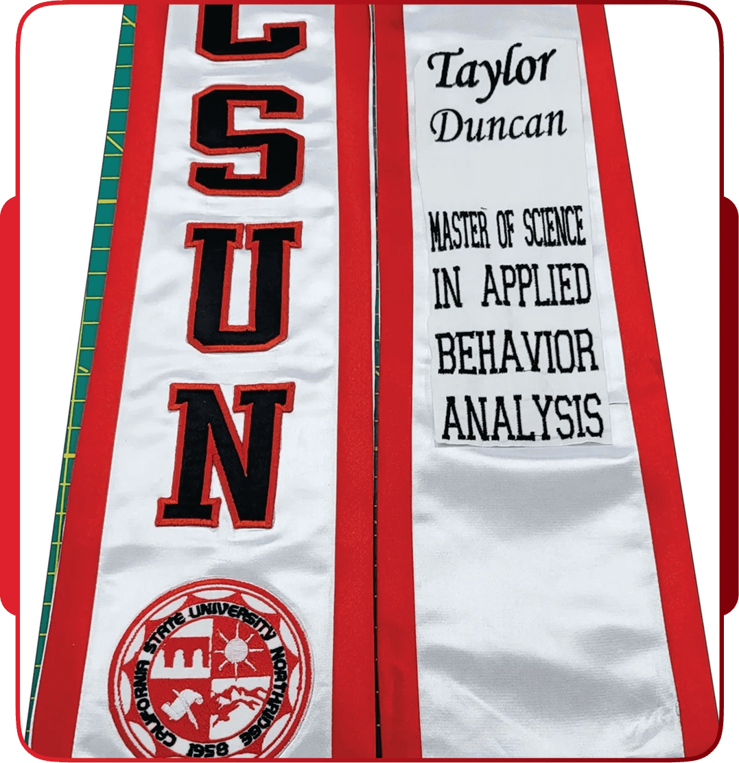 Graduate wearing a custom CSUN graduation stole outdoors