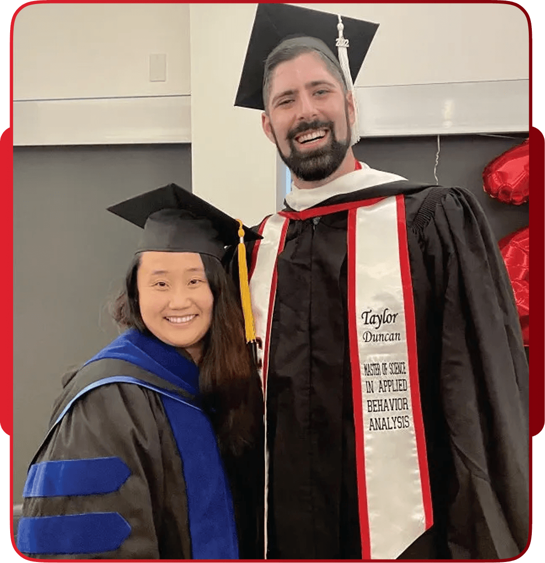 Graduates in caps and gowns with custom embroidered stole