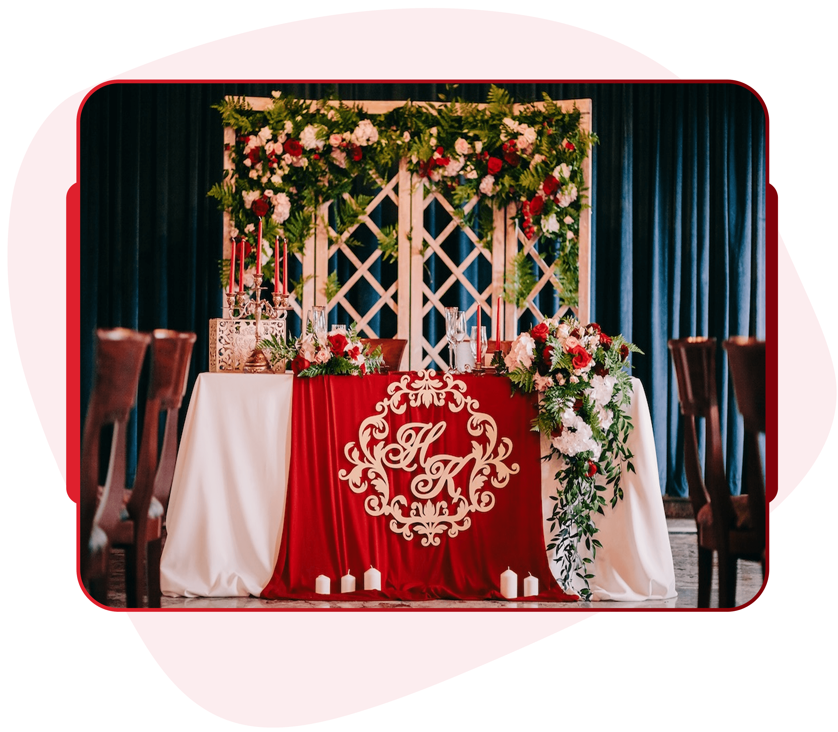 Wedding head table with custom embroidered monogram runner and floral backdrop